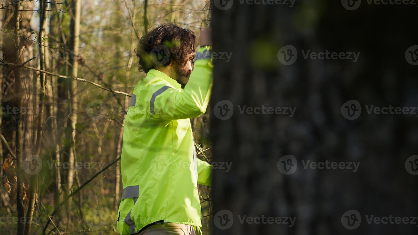 Rescue team guide leading the way into the forest area to find clues during manhunt operation, searching for a missing person. Search party screaming victim name, civil lost in the woods. Camera A. photo