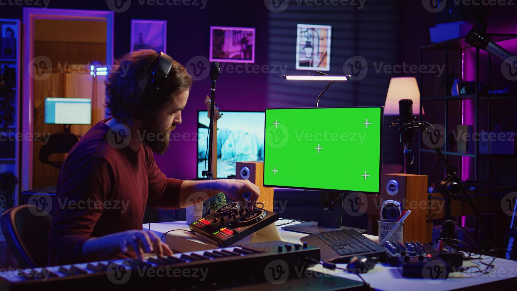 Audio engineer learning to mix piano notes with mixing console, watches online lesson tutorials on greenscreen monitor display. Music producer creating soundtracks, learns editing skills. Camera B. photo
