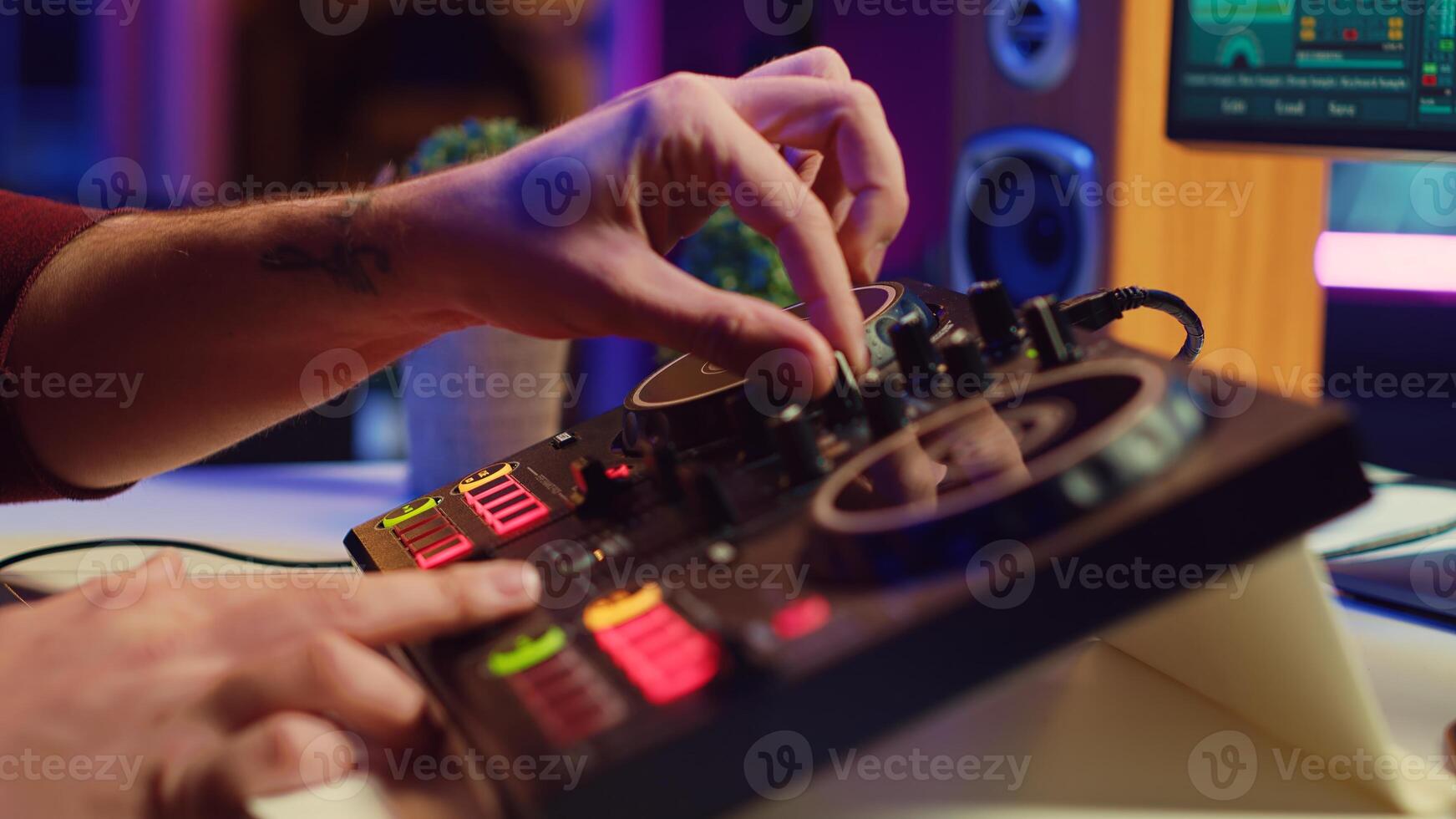 Artist editing sounds on mixing console in home studio, operating professional audio equipment to adjust volume levels on track recordings. Musician works with daw software an pre amp knobs, Camera A. photo