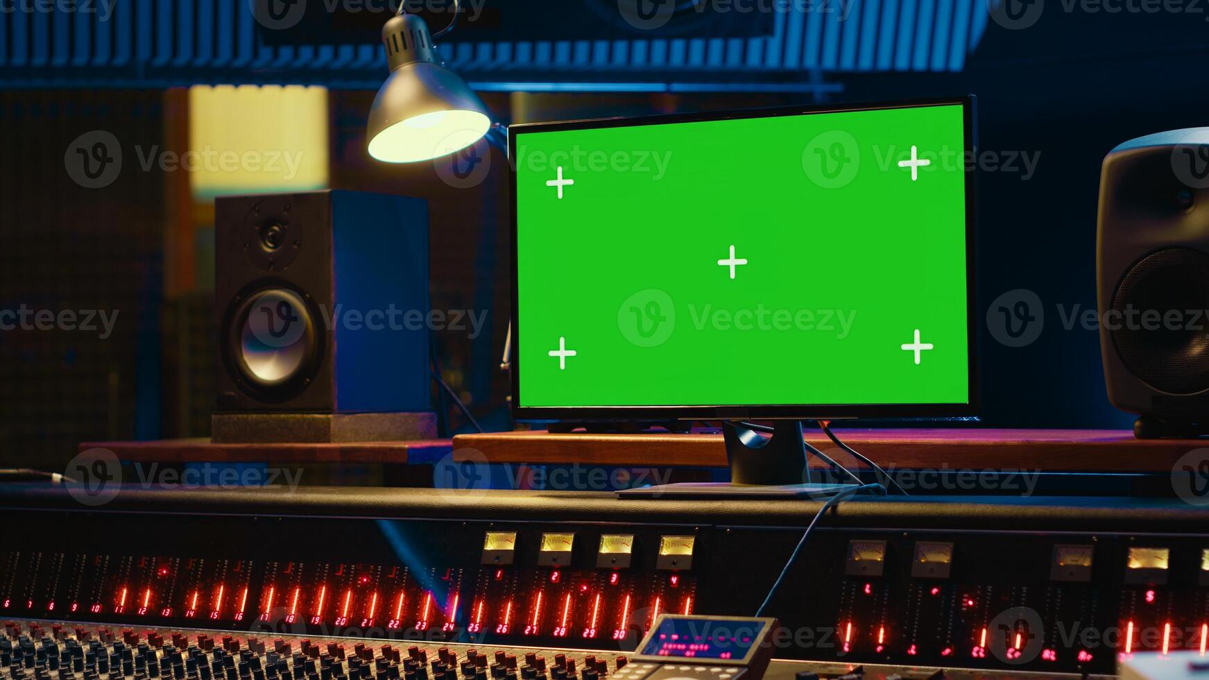 Empty professional recording studio control room with greenscreen on display, editing and processing tracks. Motorized faders, buttons and sliders operated for mix and master techniques. Camera A. photo