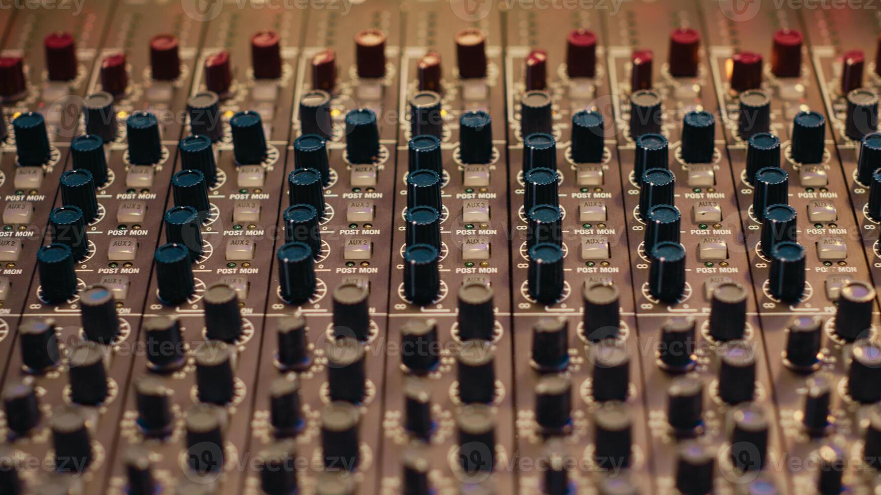 Music recording studio control room with pre amp knobs used for volume level adjustments. Stereo equipment as equalizer, mixer, switchers and sliders are operated in post production. photo