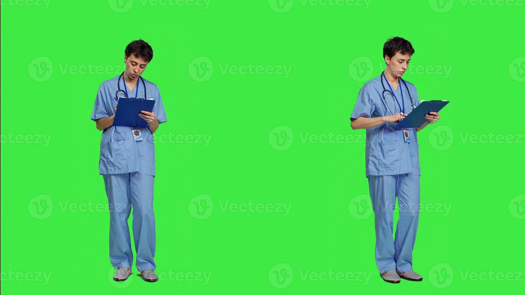 Medical assistant writing checkup information on clipboard files, taking notes and making doctor appointments with checklist. Nurse wearing blue scrubs stands against greenscreen backdrop. Camera A. photo