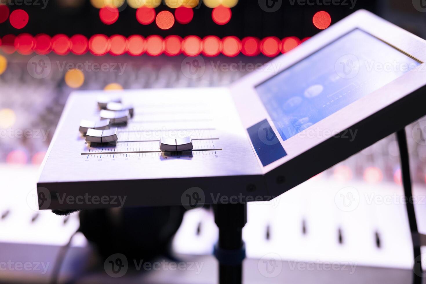 Professional recording music studio with motorized faders gear and other knobs used in post production, control room equipment. Stereo electronic tools used in editing new tracks. Close up. photo