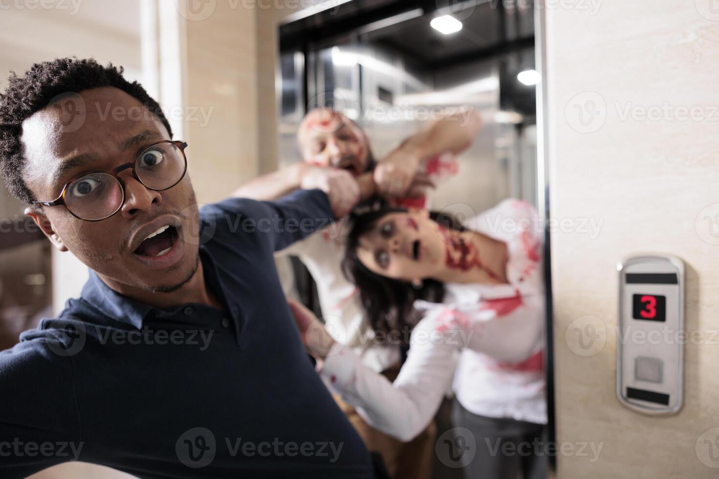 Close up of african american businessman grabbed by scary undead monsters coming out of elevator. Apocalypse survivor chased by brain eating creepy evil zombies in office building photo