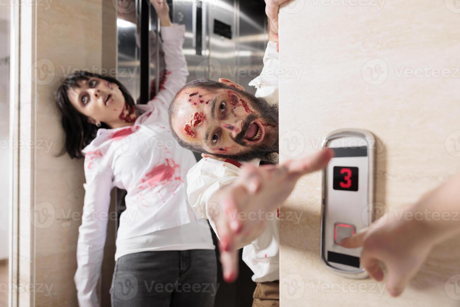 Actors playing zombies in horror movie scene coming out of elevator to infect employees. Man and woman with undead creature role in disaster film leaving escalator to kill humans photo
