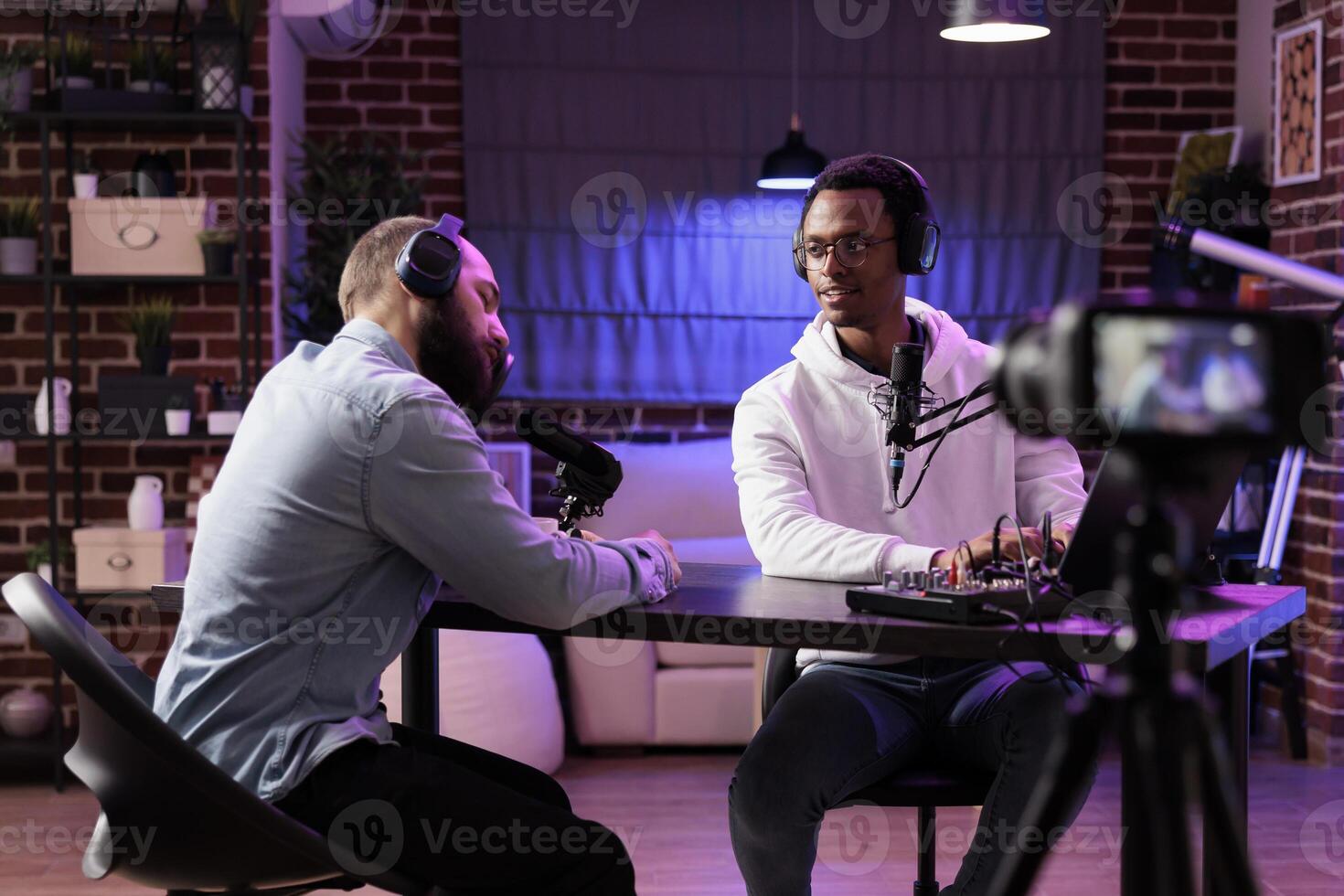 Guest on podcast feeling tired after doing marathon streaming live broadcast for good humanitarian cause, gathering donations from viewers, entertaining audience using professional equipment photo