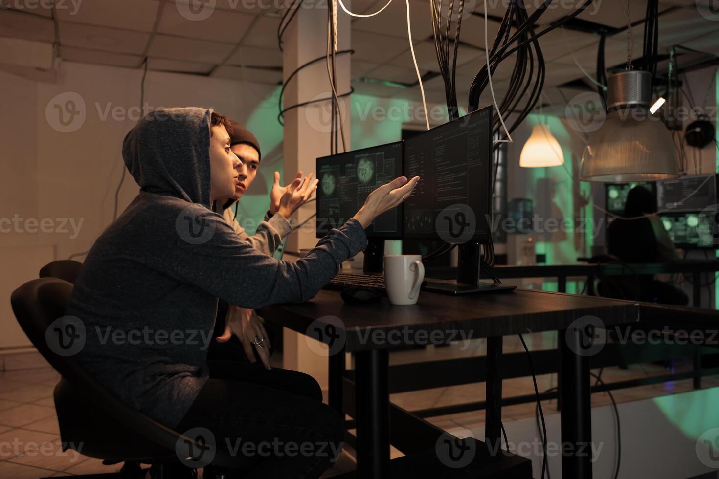 Hackers team planning cyberattack on internet, talking about malicious software code to crack firewall encryption. Online criminals breaking into database, information. Internet fraud. photo