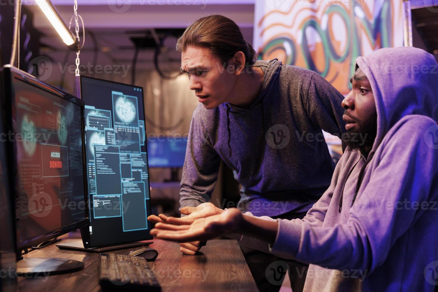 Disappointed hackers failing to break into server while looking at access denied message on computer screen. Angry unhappy criminals unsuccessfully hacking database cybersecurity system photo