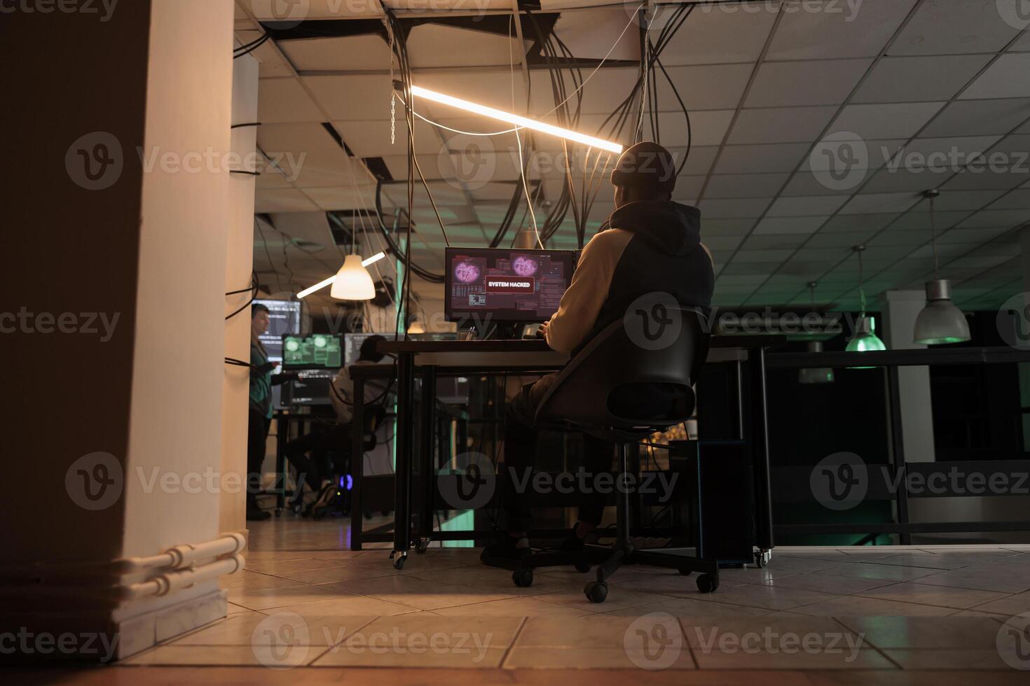 Dangerous hacker using spyware and accessing database, breaking into computer server on multiple monitors. Online criminal stealing privacy information, data phishing, cyberattack. photo