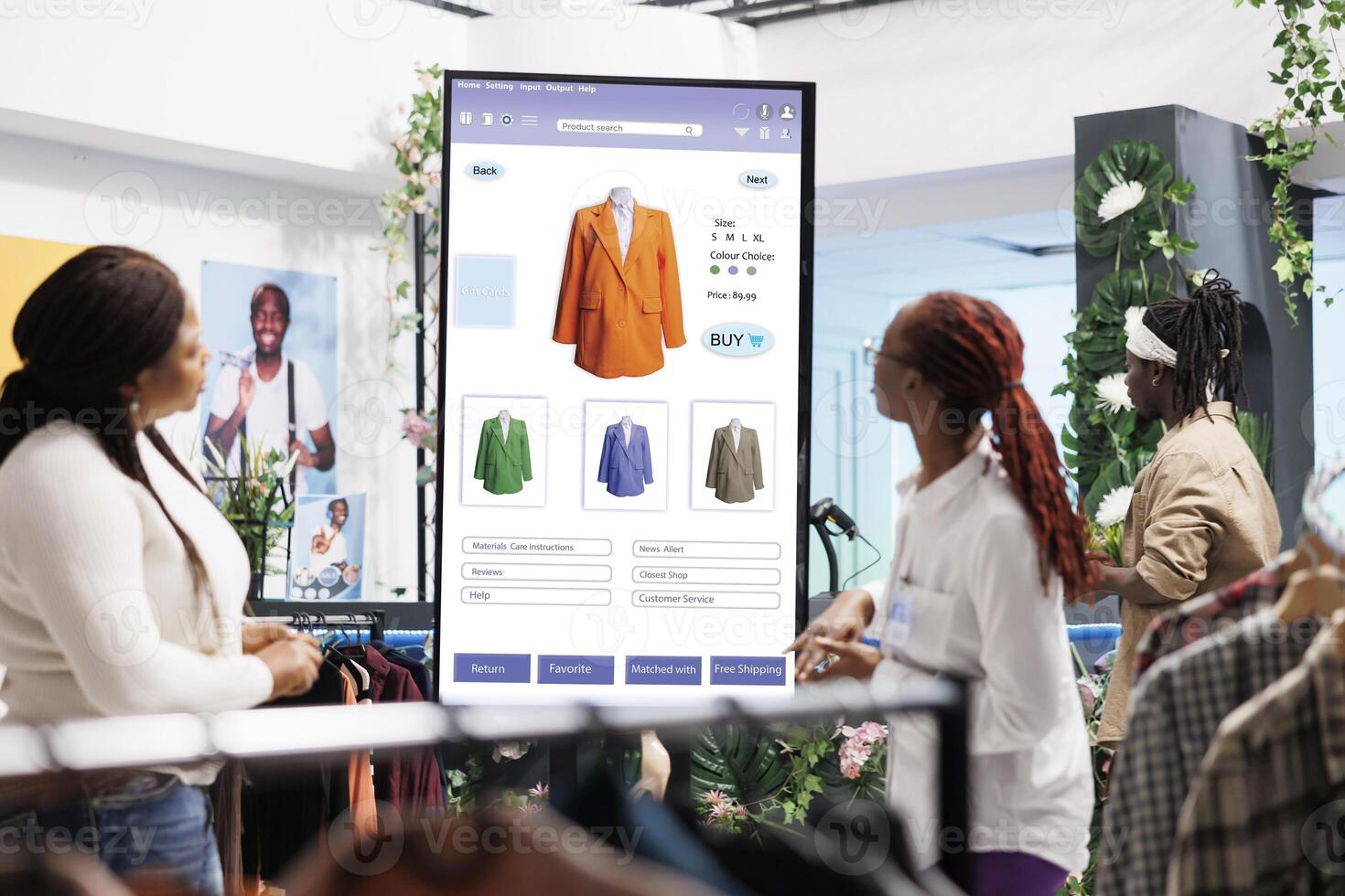 Store assistant helping client with kiosk service, female employee giving assistance in clothing store. Shopper looking for trendy items on interactive board monitor, self ordering. photo