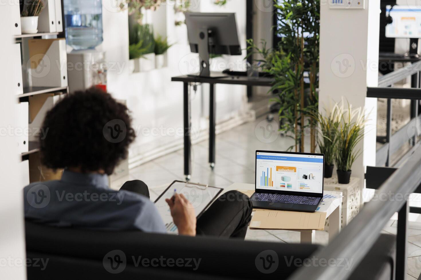 Arab businessman analyzing financial data on laptop screen in startup office. Executive manager comparing sales metrics and checking investment revenue statistics in coworking space photo