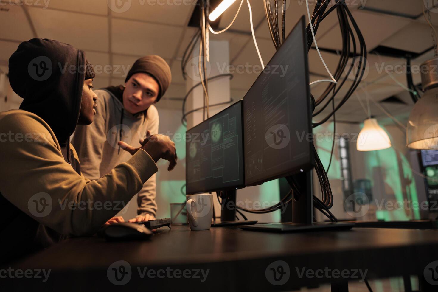 Team of hackers looking at spyware and phishing technology to hack government network. Criminals working on identity theft with malware and virus, planning security breach at night. photo