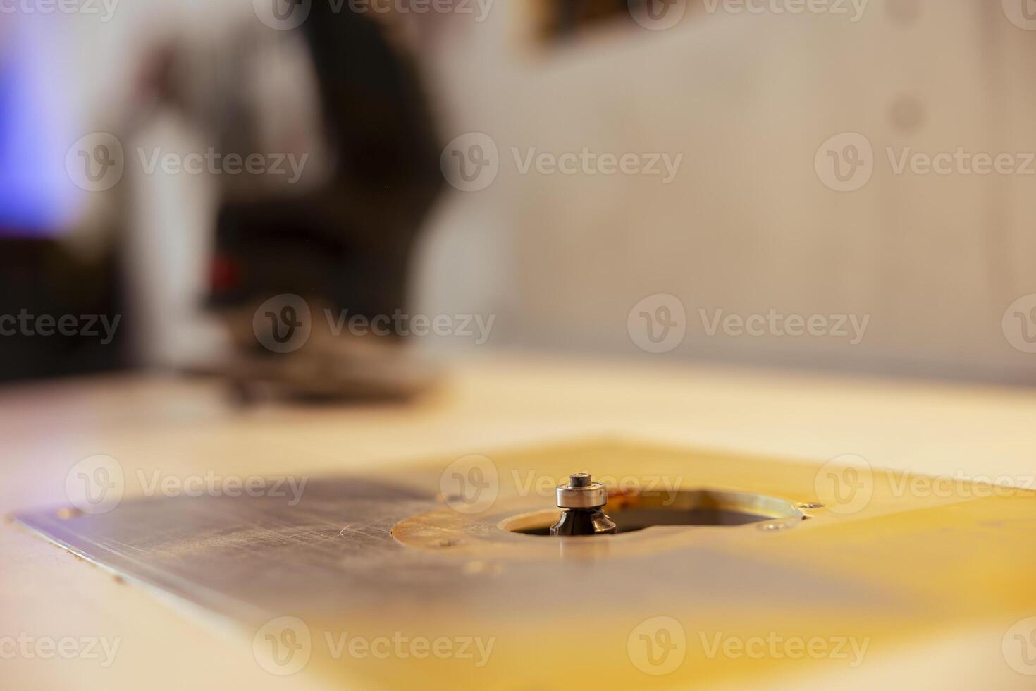 Close up shot of edge jointer in carpenter studio used for precision cutting of wood blocks, making wooden objects. Focus on router planer used in woodworking for smoothing out panels photo