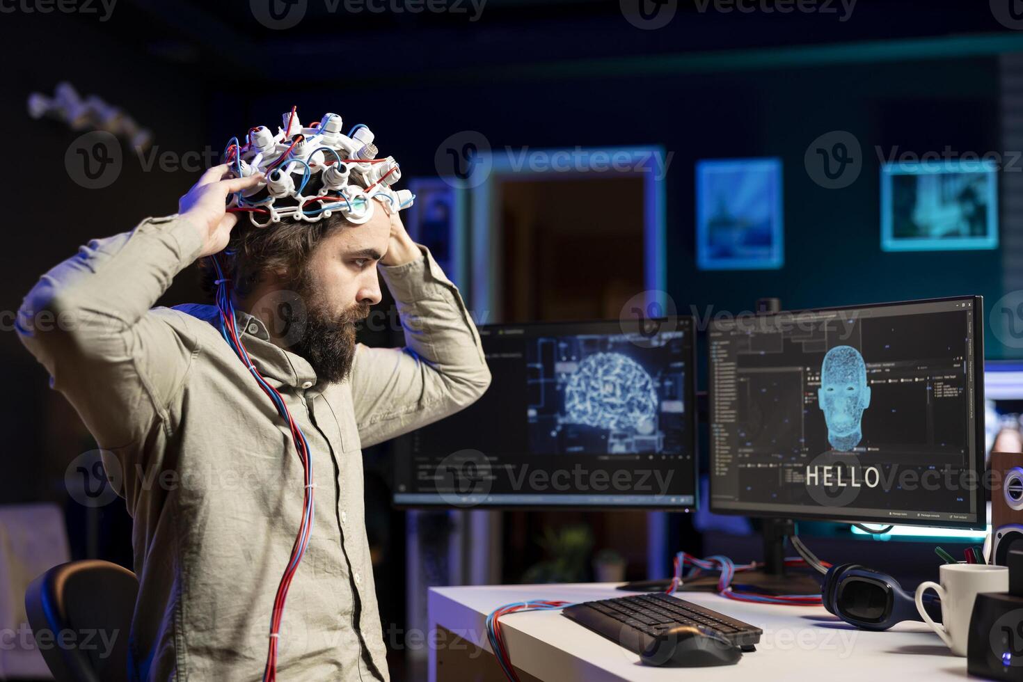IT specialist putting EEG headset on to communicate with artificial intelligence on computer in binary code. Software engineer sending brainwave signals to sentient AI on PC using high tech device photo