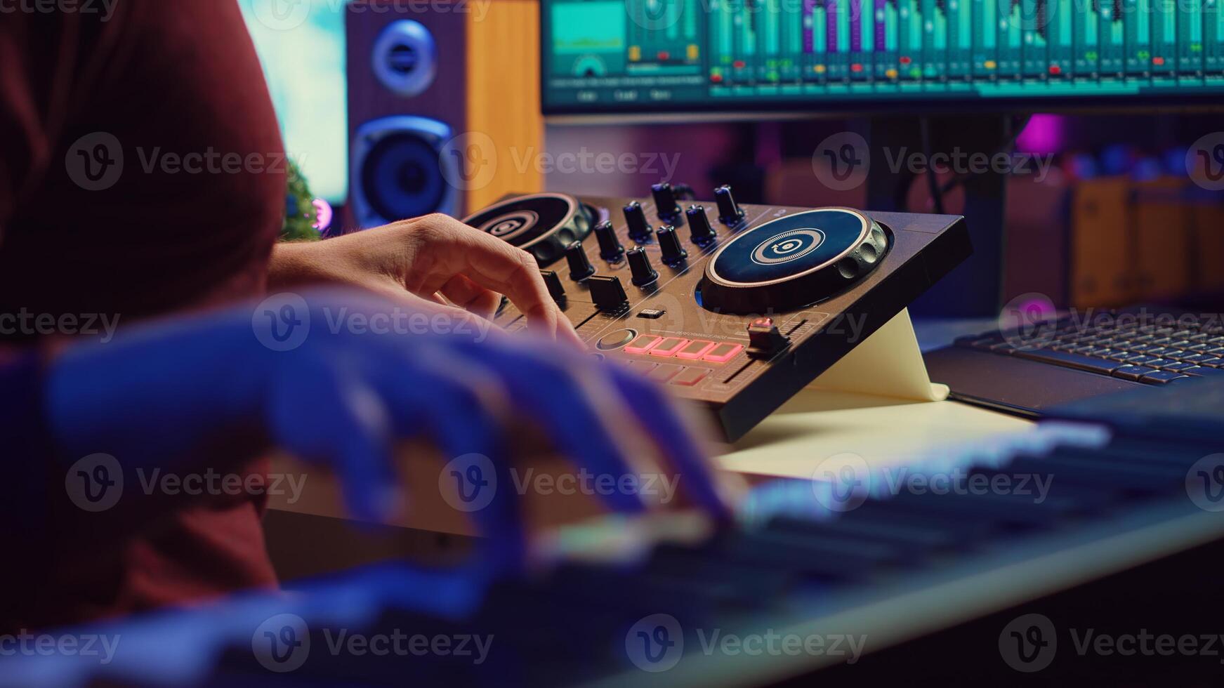 Skilled artist playing piano keyboard and recording sounds on daw software, capturing audio track instruments and vocals. Producer creating songs with mixing console in post production. Camera A. photo