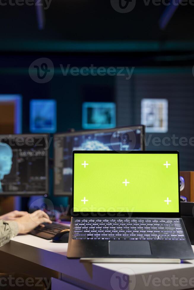 Focus on green screen laptop used by developer to update artificial intelligence machine learning algorithm. Close up of IT expert in apartment using programming to upgrade AI on mockup notebook photo