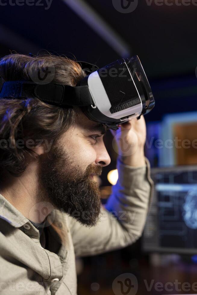 IT expert using virtual reality to make artificial intelligence become sentient, smiling after seeing self awareness signs. Man with VR glasses on happy after achieving AI superintelligence, close up photo