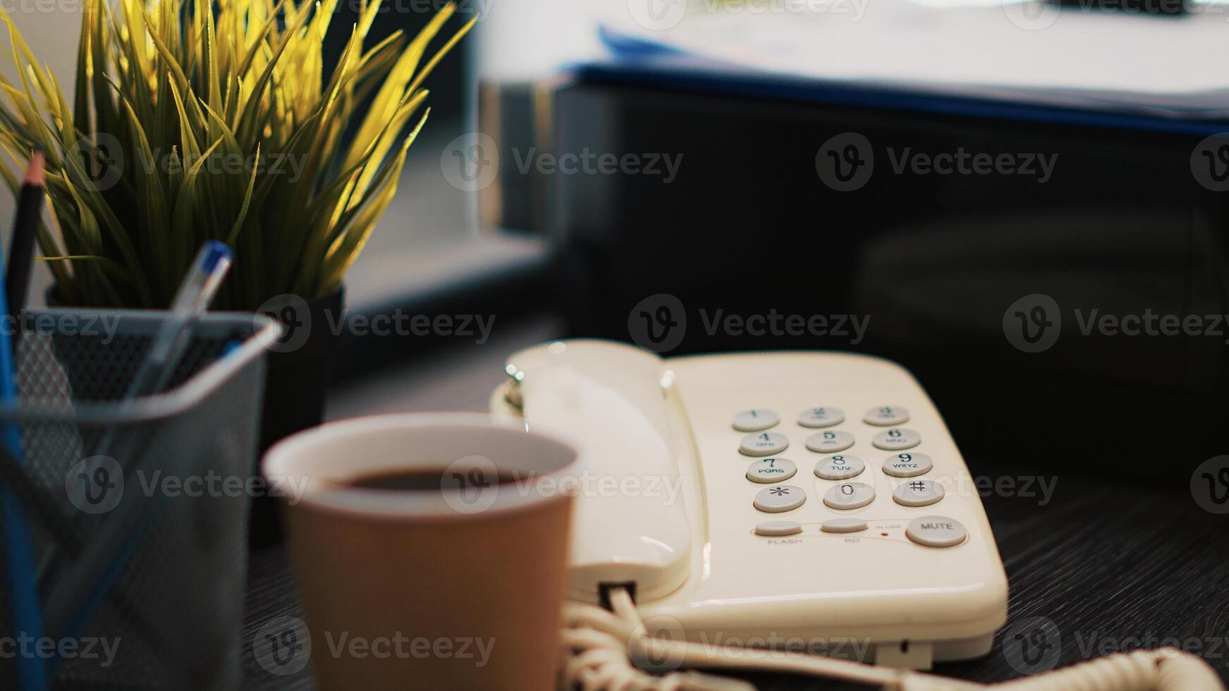 Cup of coffee on office desk next to paperwork containing business financial information income statements, close up shot. Company invoice documents and hot beverage in accounting workspace photo