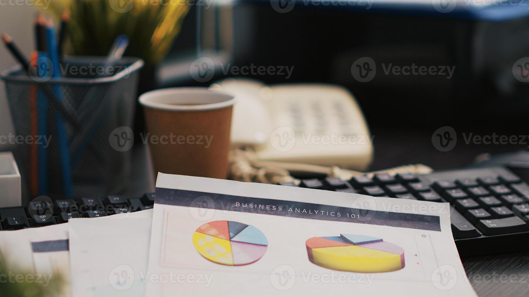 Audit report on desk next to paper cup of coffee in empty accounting department office, close up shot. Clipboard with papers containing economic graphs and figures near hot beverage on table photo