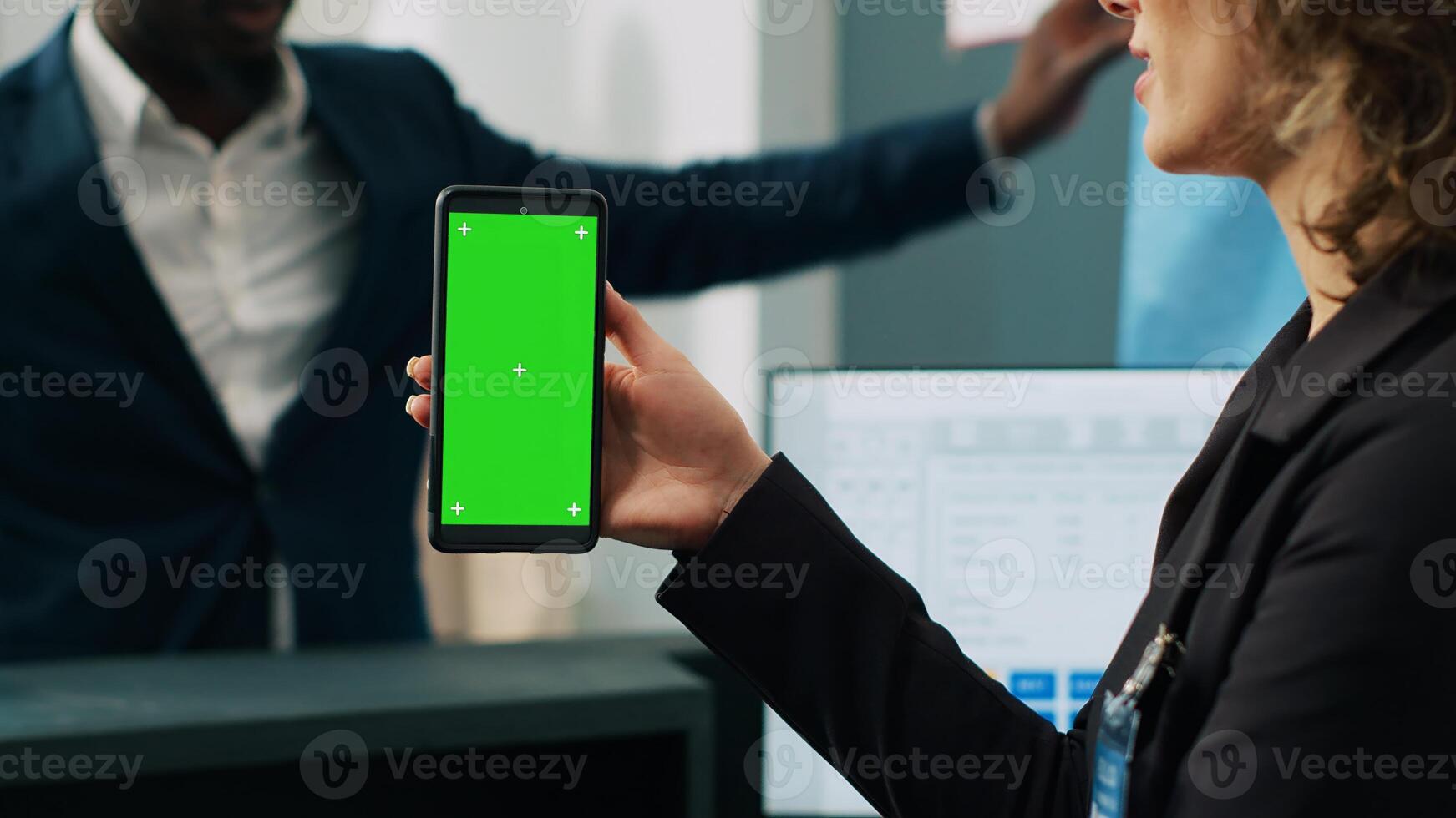 Mall employee showing greenscreen layout on phone at checkout counter, working in fashion industry and selling clothing. Assistant looking at mobile device display with mockup template. Camera A. photo