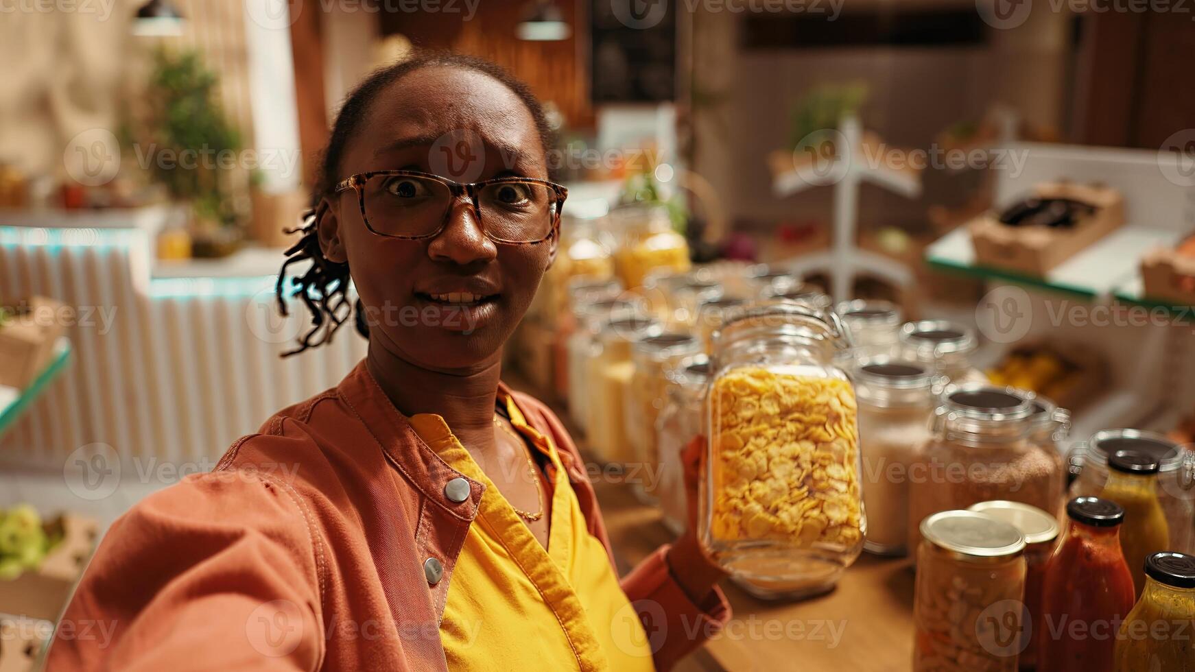 POV of african american client promoting local bio supermarket on social media networks, filming online to create ad. Woman presenting additives free bulk items and produce. Handheld shot. photo