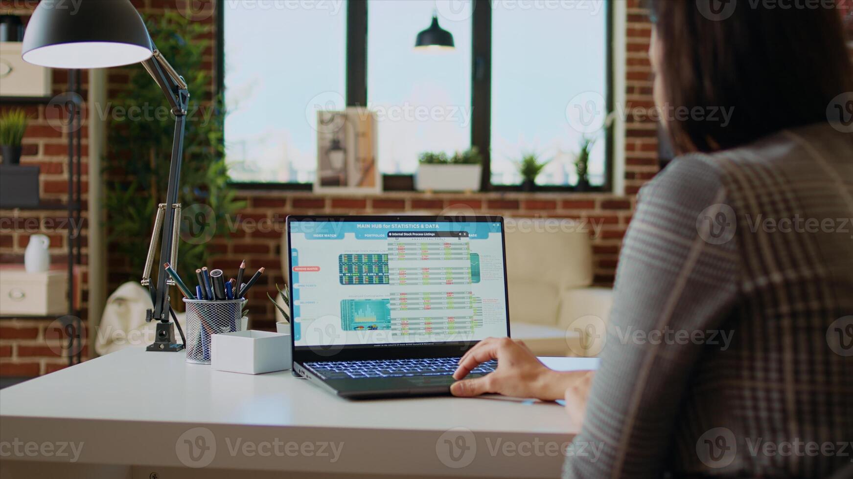 Remote stockholder analyzing investment financial profit by looking at market shares graphs. Professional broker investor checking stock exchange valuation while working from home, camera A photo