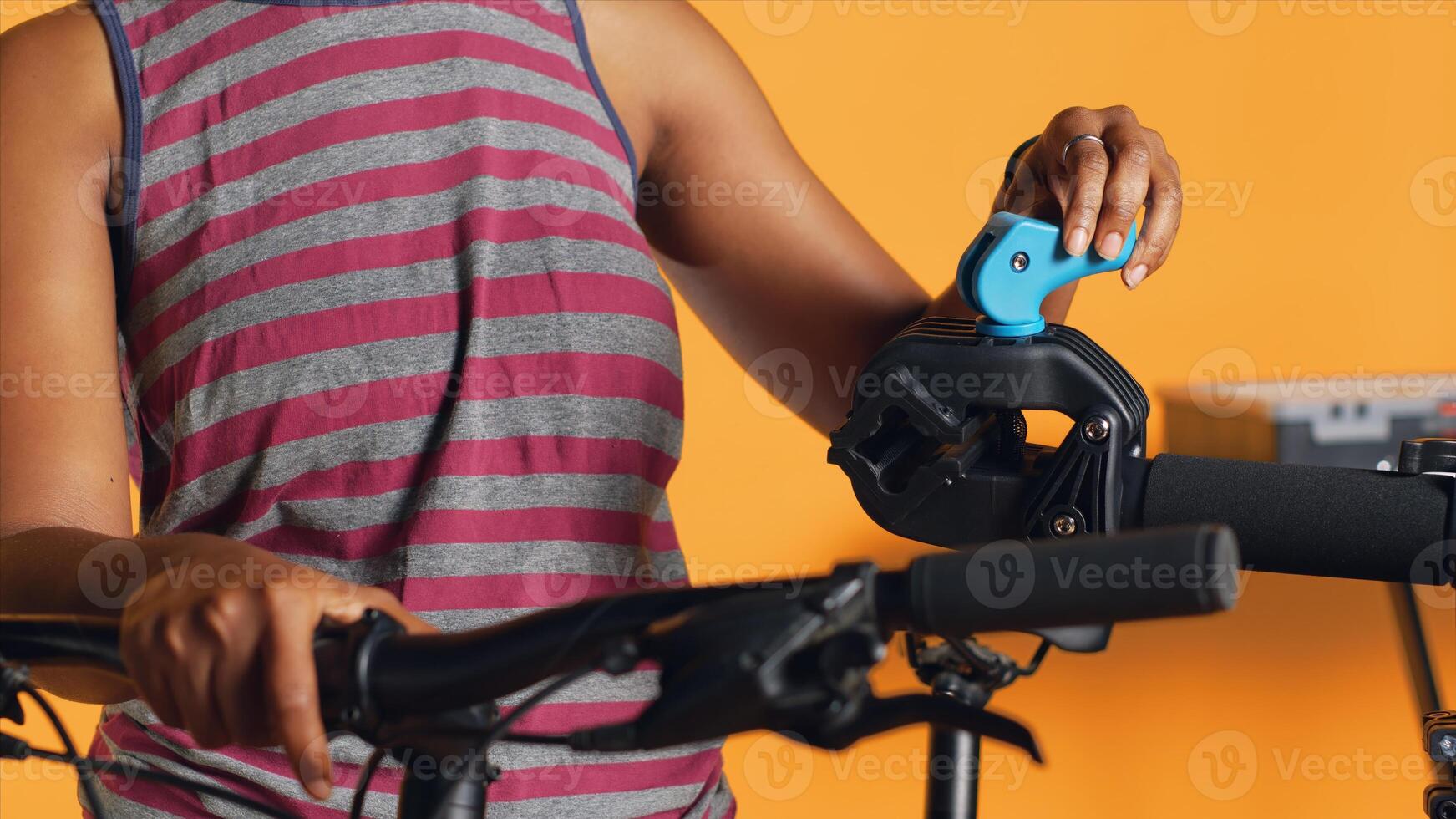 Technician setting up bike repair stand, using it to adjust derailleur and cables, mending damaged wheels, close up shot. Specialist assembling workstand to do bicycle maintenance, camera A photo