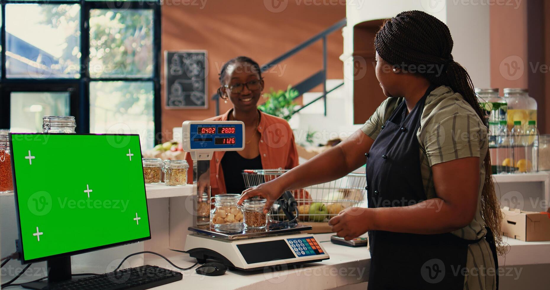 Shopper purchasing goods next to greenscreen on monitor, isolated mockup template on pc at cash register in supermarket. Vendor working with display running copyspace layout. Tripod shot. photo