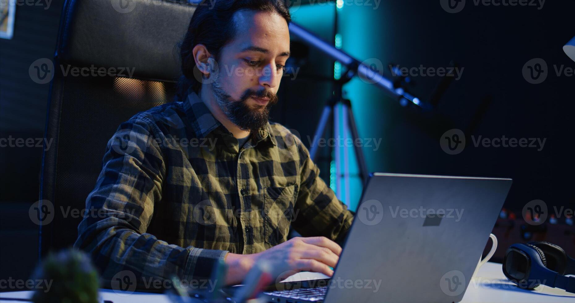 Portrait of smiling freelancer working from home, typing on laptop, surfing the net. Joyful remote employee browsing on digital device, sending emails to customers, camera B photo