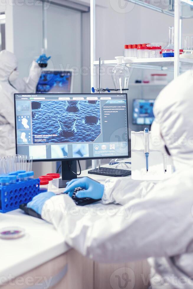 Doctor doing research in laboratory during coronavirus Lab engineers conducting experiment for vaccine development against covid19 virus photo