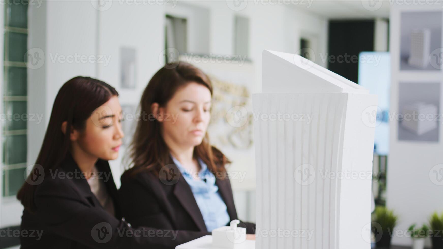 Office engineers studying 3d printed model in coworking space, calculating architectural scales and measurements. Contractors team translating building proportions for project plans. photo