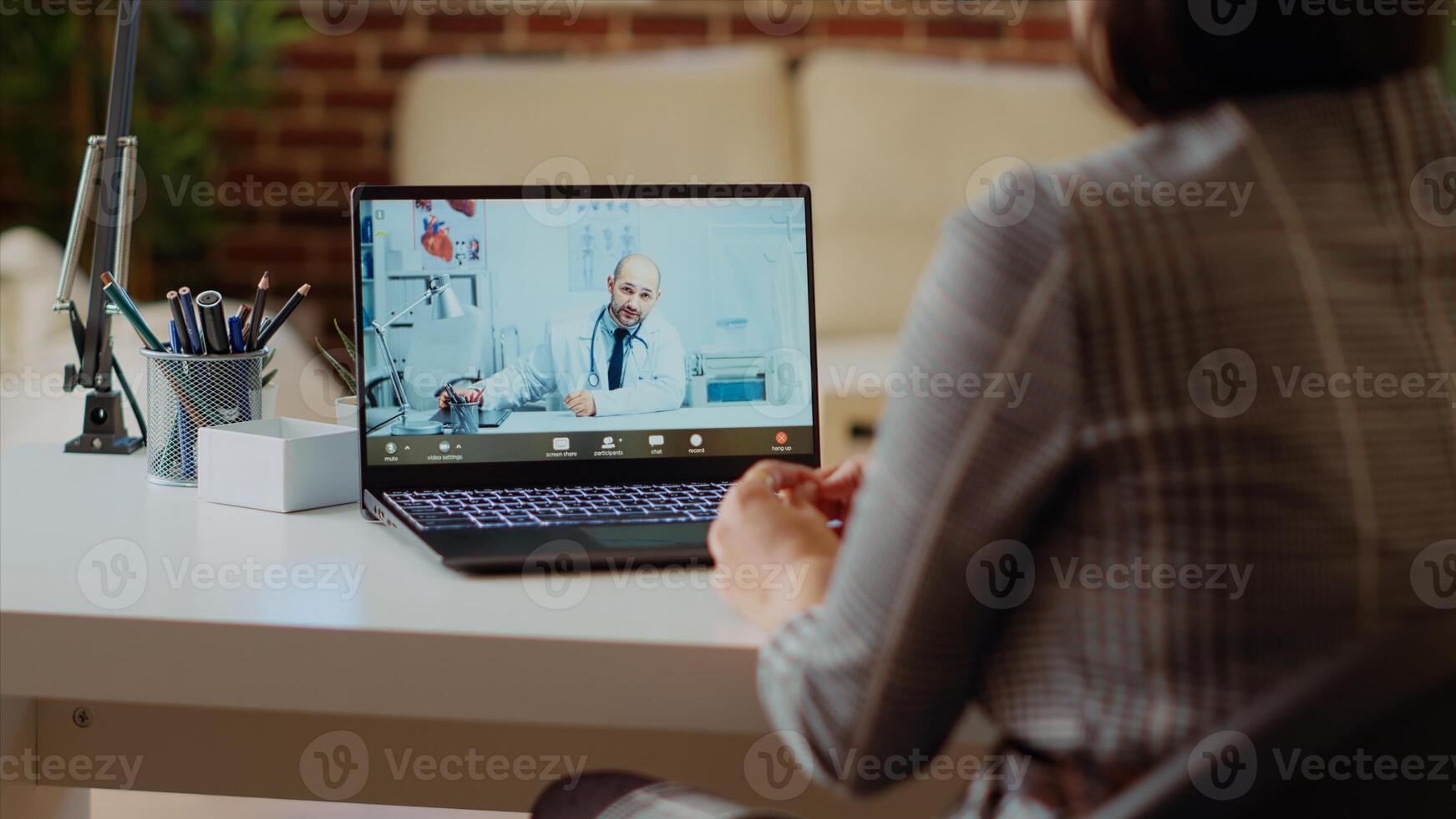 Remotely working employee in telemedicine call asking for medical advice, feeling sick. Teleworker in online consultation checkup with doctor, receiving prescription plan, camera B photo