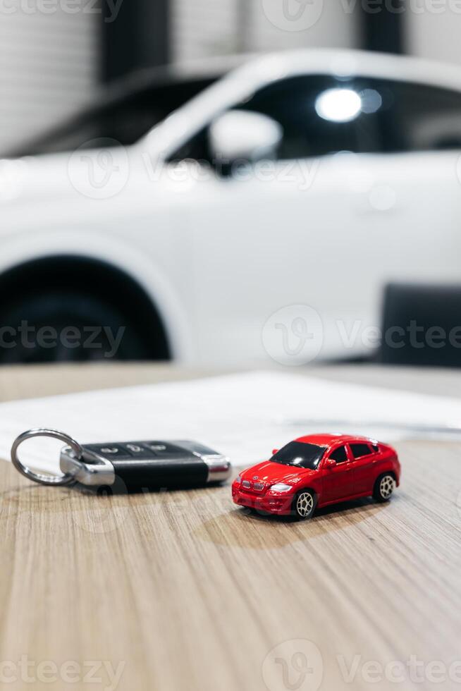 Buying or selling new or used vehicle with car keys on table. Transport insurance purchase and rental photo