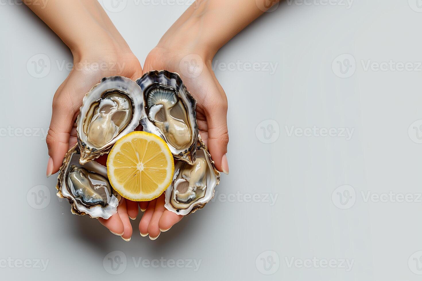 Hands holding open oysters isolated on white background. Fresh oysters with slice of lemon photo