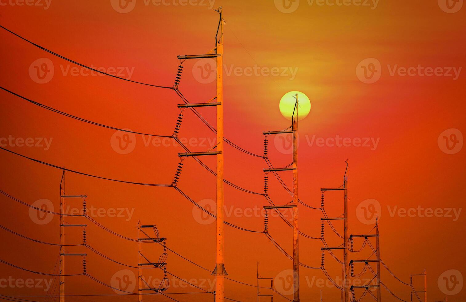 Electricity post near the field at sunset background. photo
