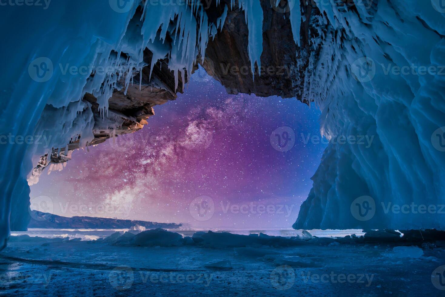 Landscape of milky way on sky with natural breaking ice inside blue ice cave on Lake Baikal, Siberia, Russia. photo