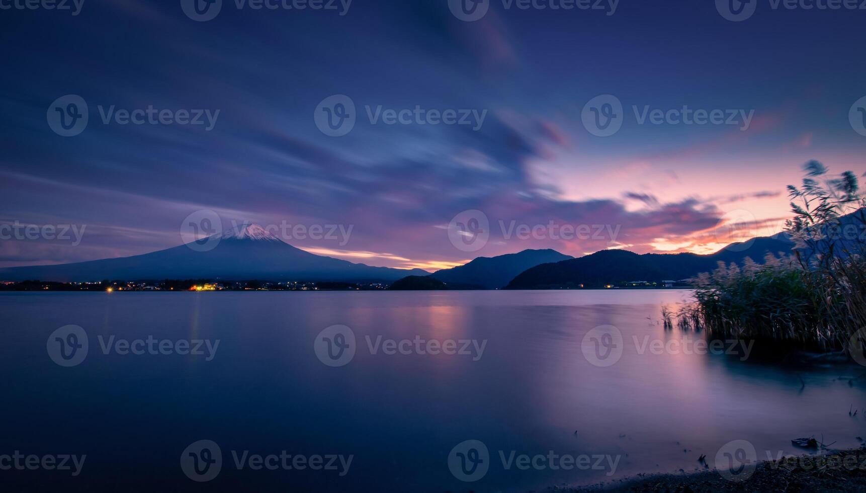 Landscape image of Mt. Fuji over Lake Kawaguchiko at sunset in Fujikawaguchiko, Japan. photo