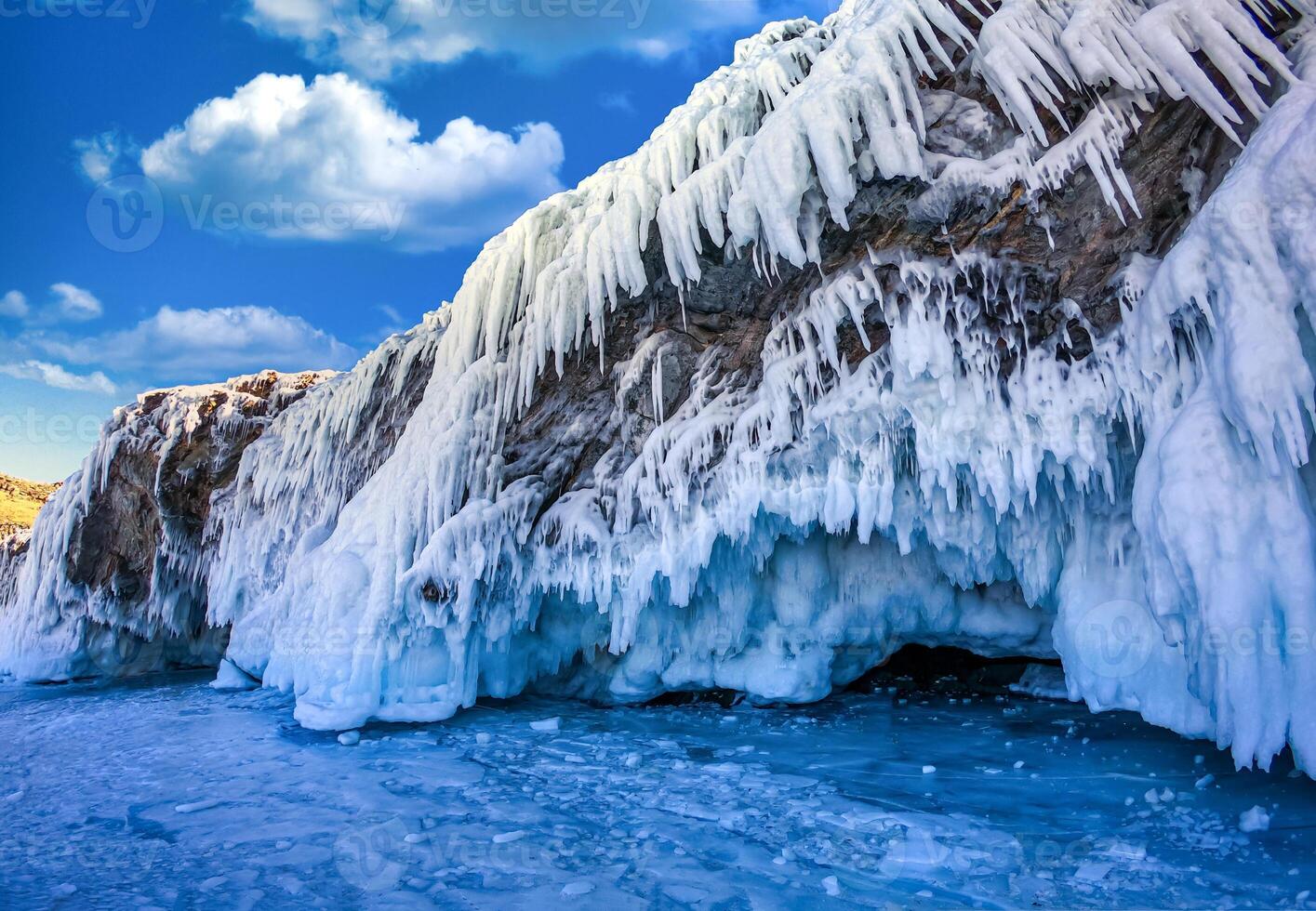 Landscape of Mountain at daytime with natural breaking ice in frozen water on Lake Baikal, Siberia, Russia. photo