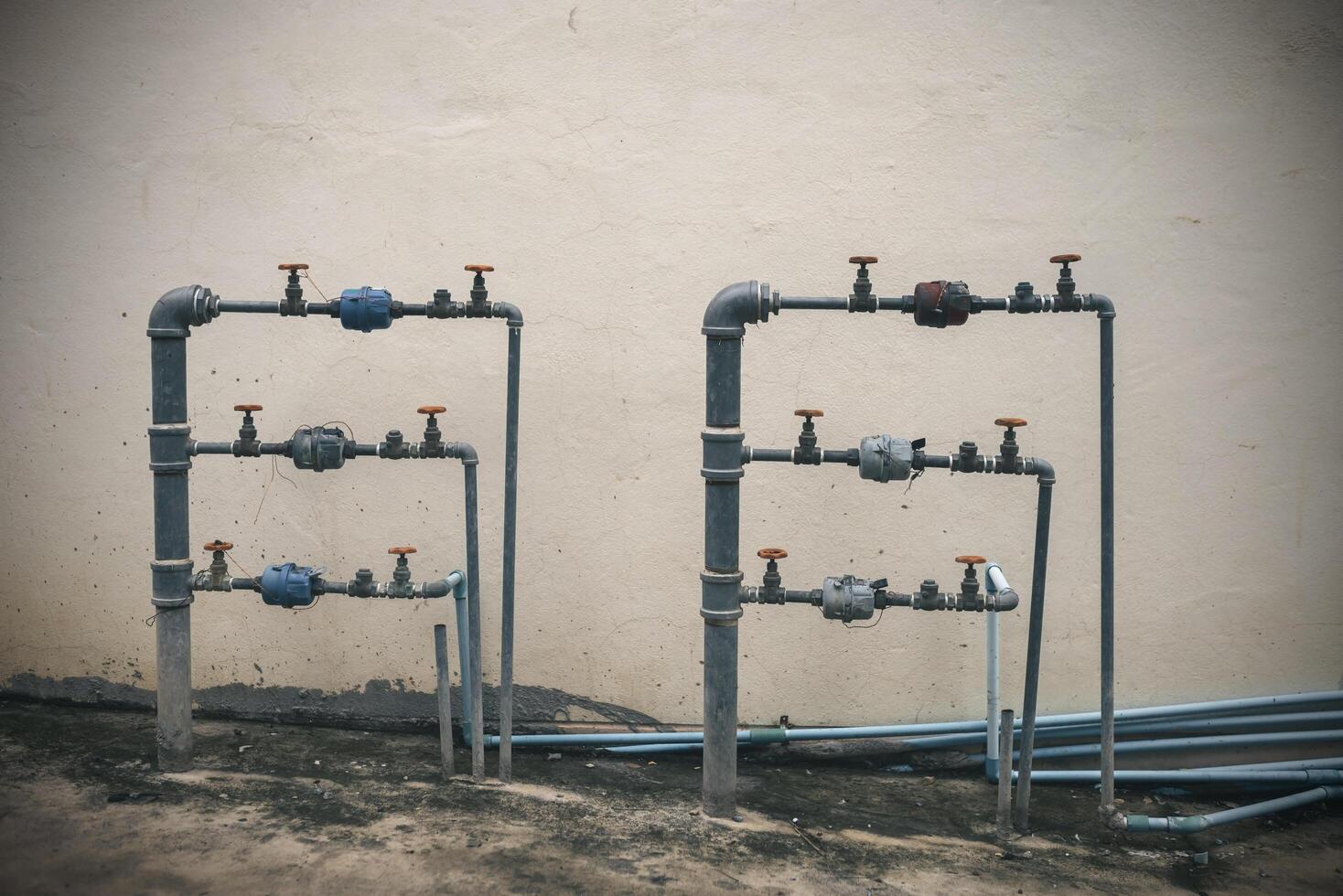 Steel water pipes with water meters with twisted water valves. photo