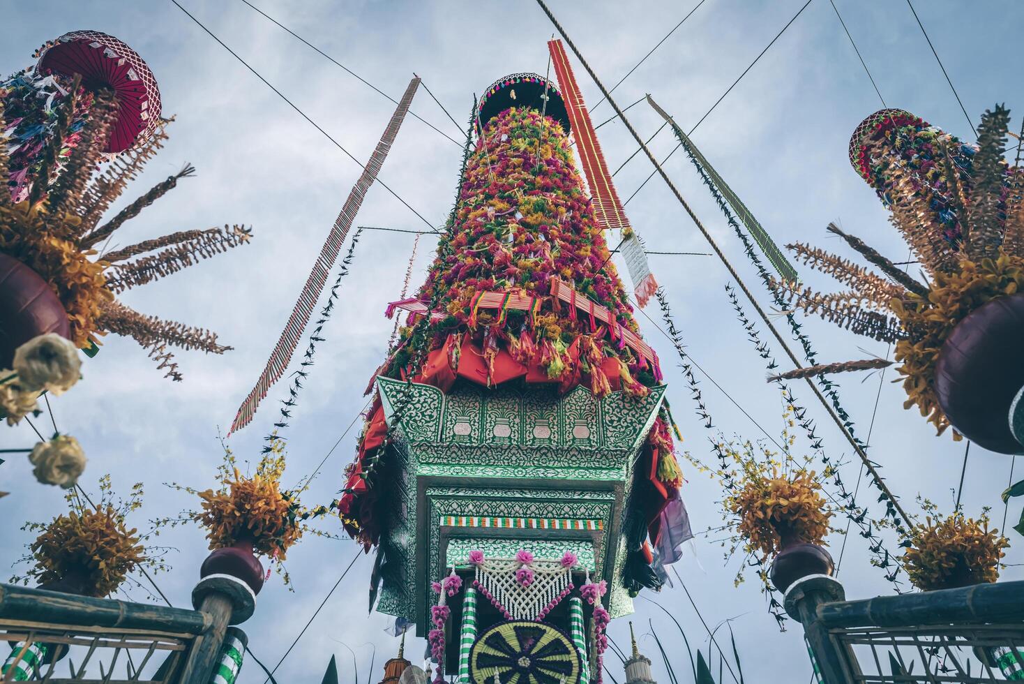 Salak yom at Wat Phra That Hariphunchai in Lamphun. The tradition of making merit, the tall dyed lott trees are decorated with different colored paper and clothing items to pay homage to the souls. photo