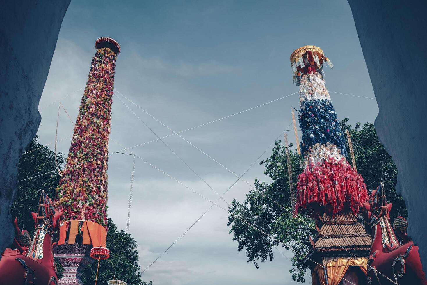 Salak yom at Wat Phra That Hariphunchai in Lamphun. The tradition of making merit, the tall dyed lott trees are decorated with different colored paper and clothing items to pay homage to the souls. photo