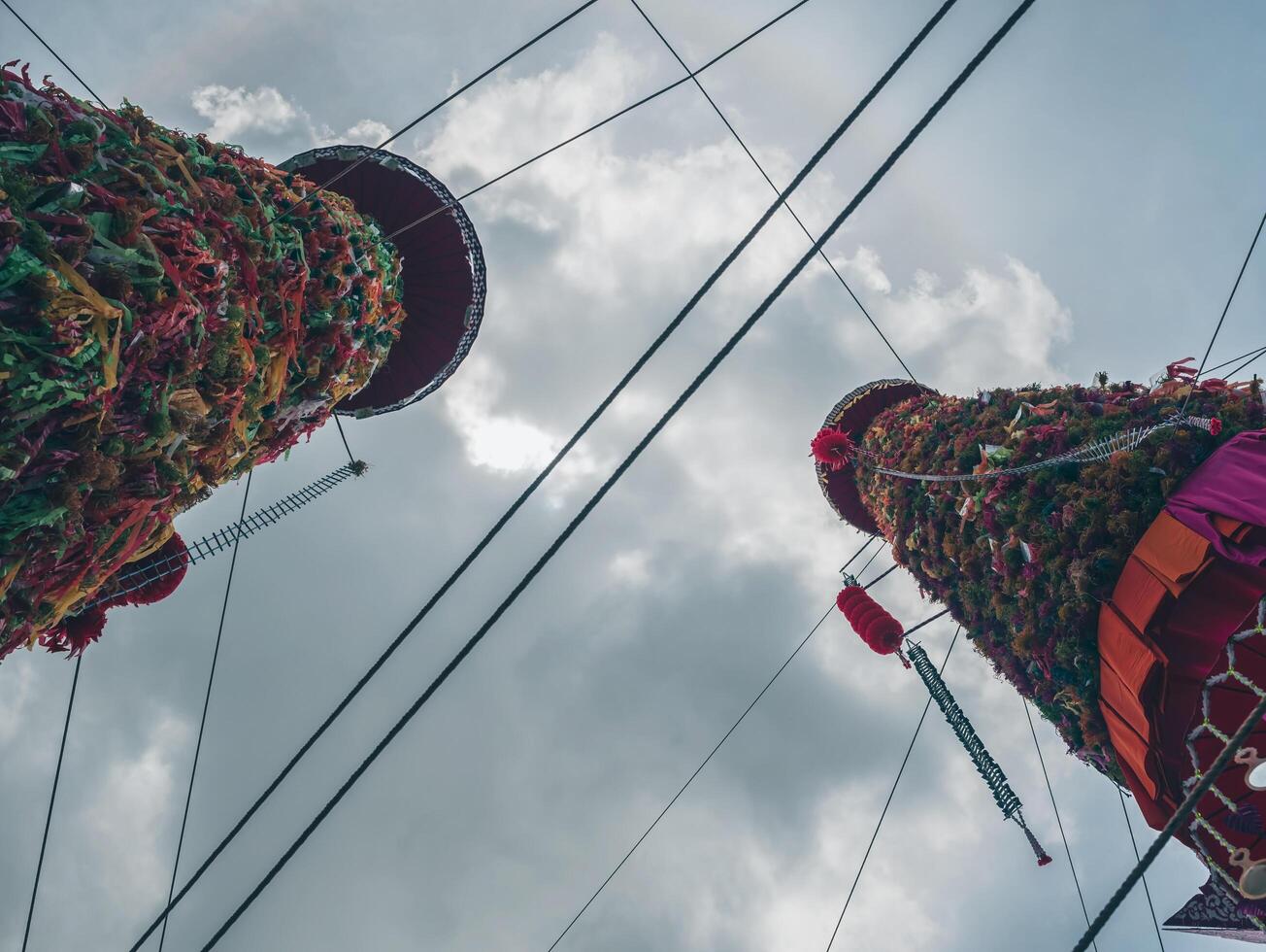 Salak yom at Wat Phra That Hariphunchai in Lamphun. The tradition of making merit, the tall dyed lott trees are decorated with different colored paper and clothing items to pay homage to the souls. photo
