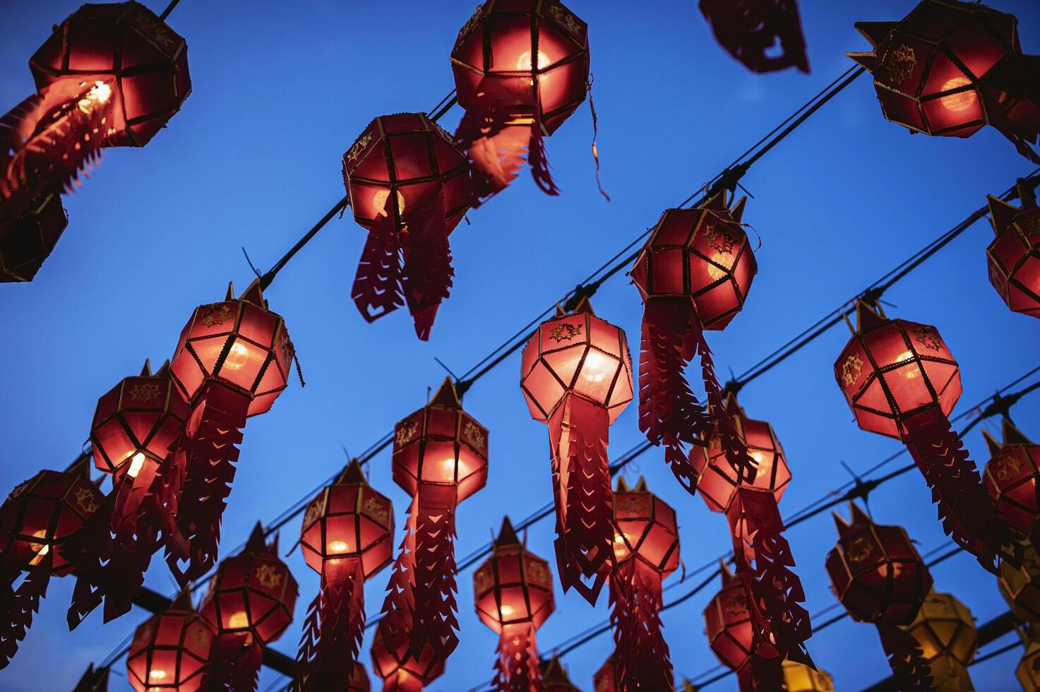 Lanterns made of colorful paper are hung during the annual festival at Wat Phra That Hariphunchai in Lamphun Province. photo