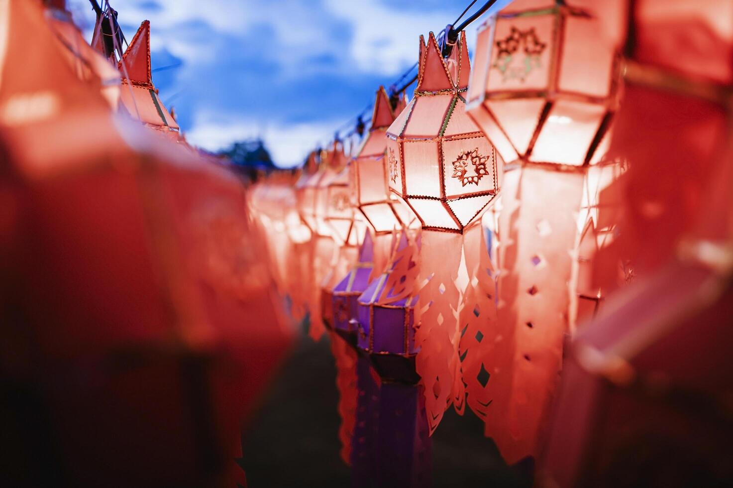 Lanterns made of colorful paper are hung during the annual festival at Wat Phra That Hariphunchai in Lamphun Province. photo