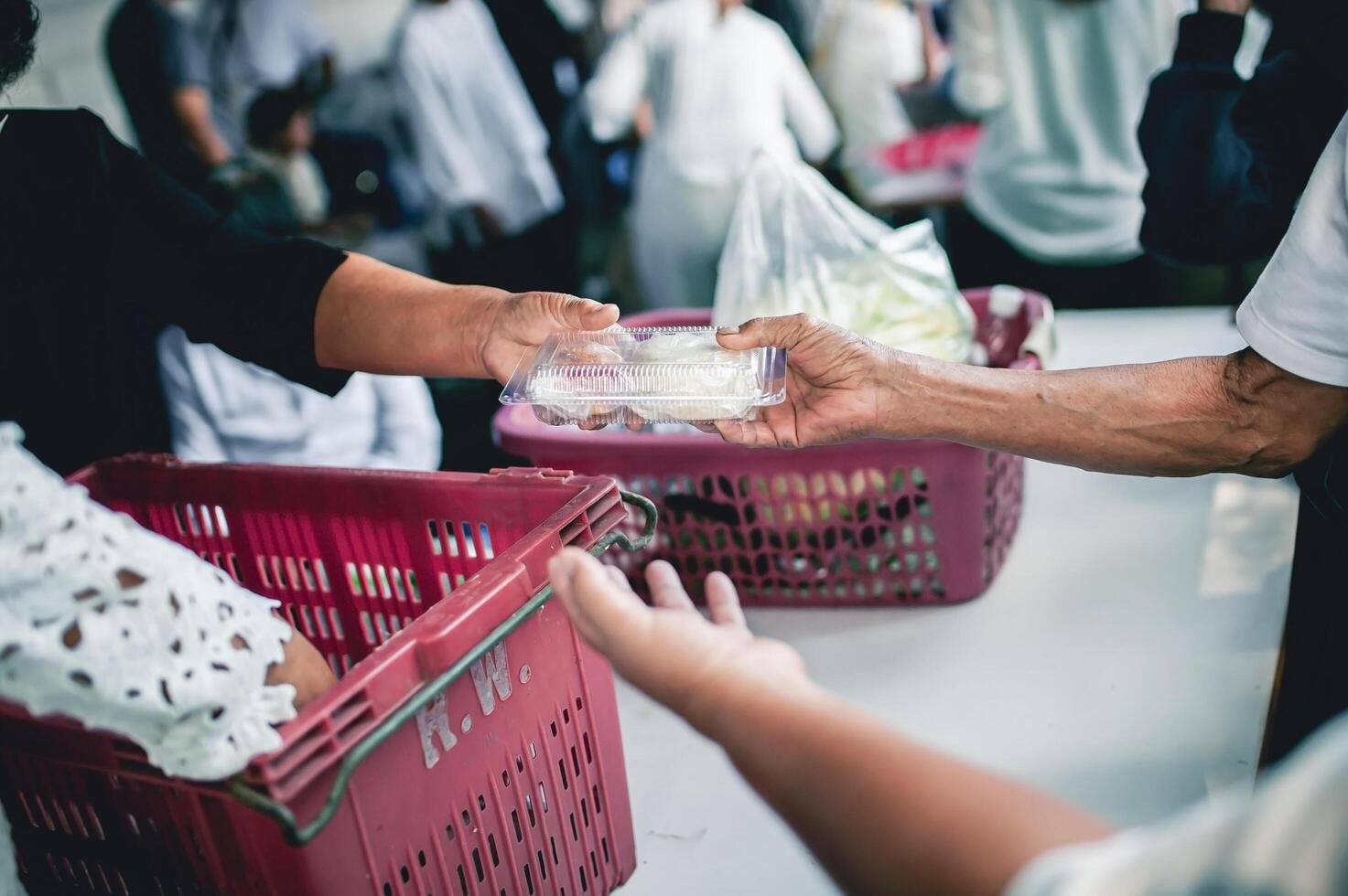 Poor people receive donated food from donors photo