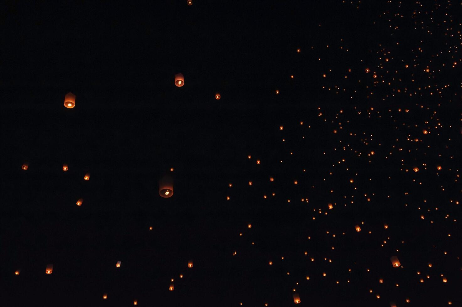 The beauty of the lanterns floating in the sky during the Yi Peng Festival and the Floating Lantern Festival in Chiang Mai Province, Thailand. photo