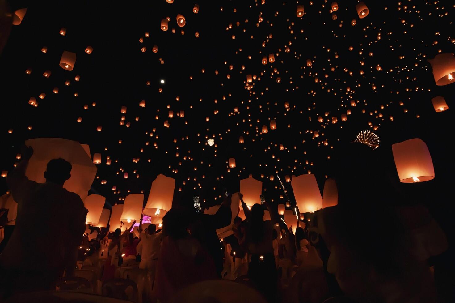The beauty of the lanterns floating in the sky during the Yi Peng Festival and the Floating Lantern Festival in Chiang Mai Province, Thailand. photo