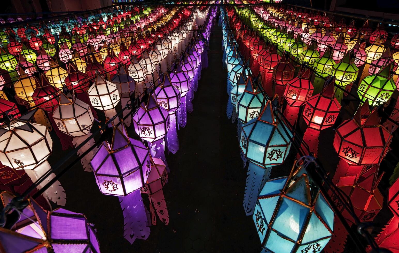 Lanterns made of colorful paper are hung during the annual festival at Wat Phra That Hariphunchai in Lamphun Province. photo