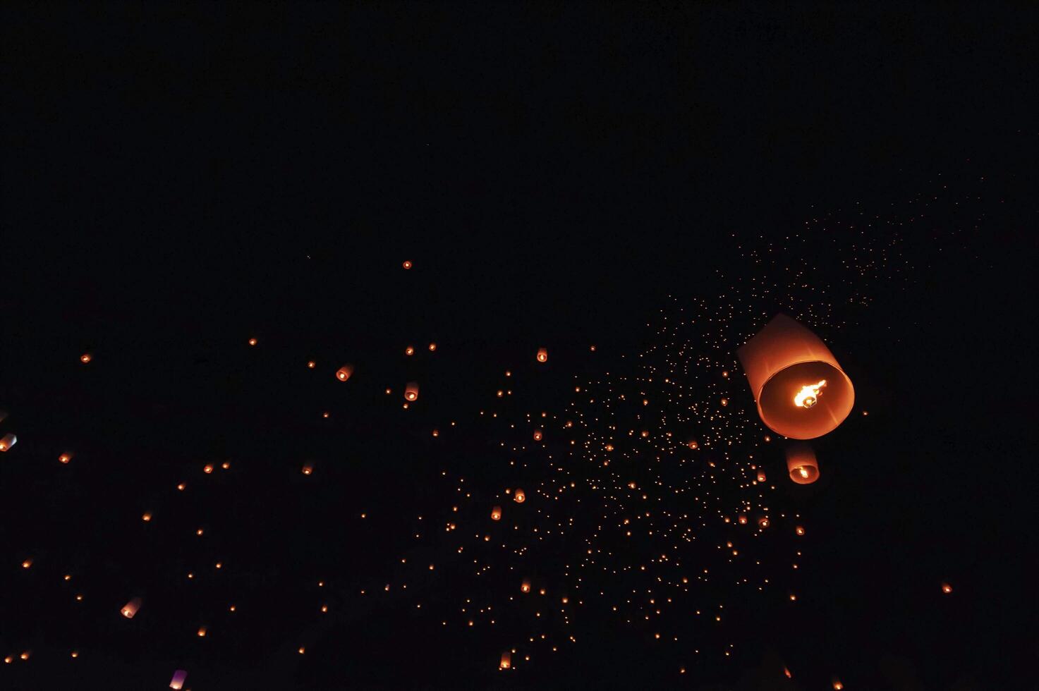 The beauty of the lanterns floating in the sky during the Yi Peng Festival and the Floating Lantern Festival in Chiang Mai Province, Thailand. photo