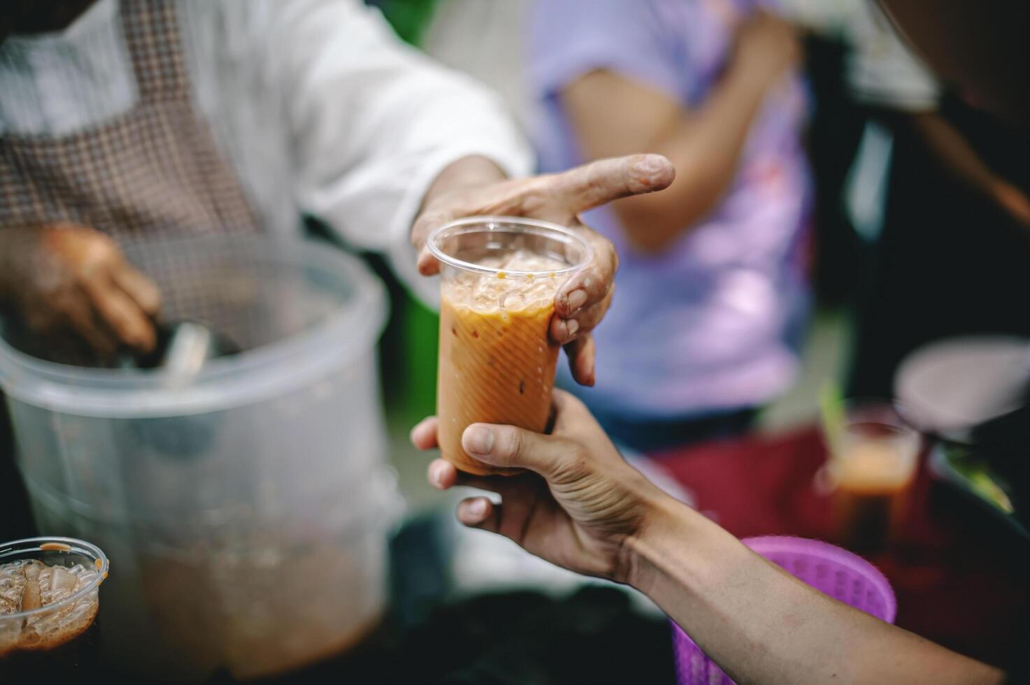 Volunteers offer free food to the poor. the concept of food sharing. photo